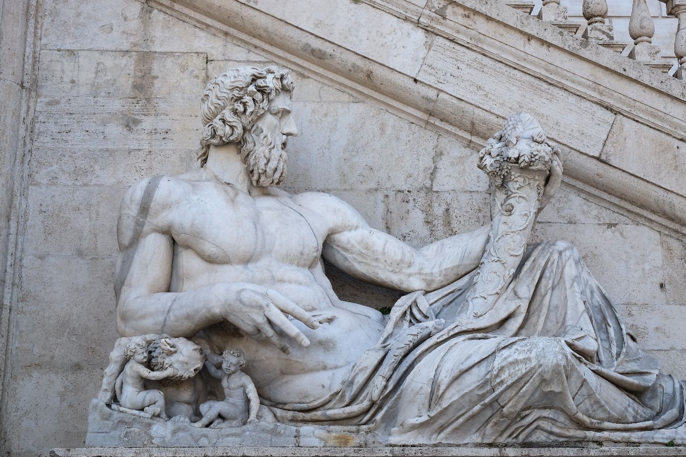 Ancient marble statue in Rome, Italy of Romulus and Remus being protected by Roman God